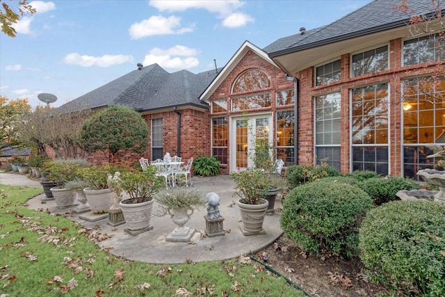 1305 Bentbrook Ln, Sherman, TX 75092 - back of property featuring brick siding, a patio, and a shingled roof
