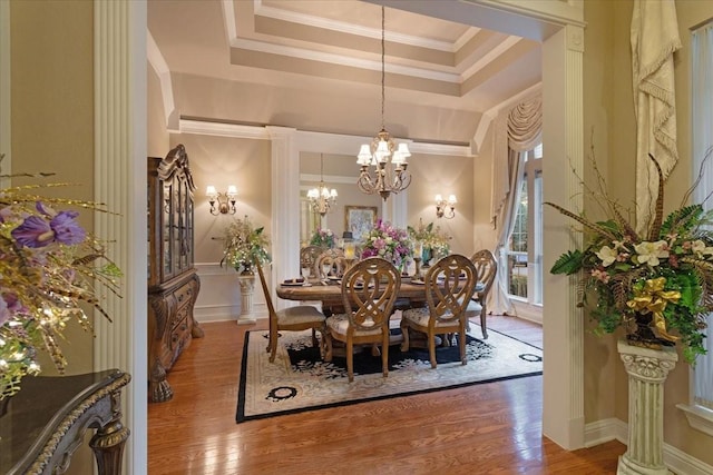 1305 Bentbrook Ln, Sherman, TX 75092 - dining space featuring wood finished floors, a chandelier, a raised ceiling, and ornamental molding
