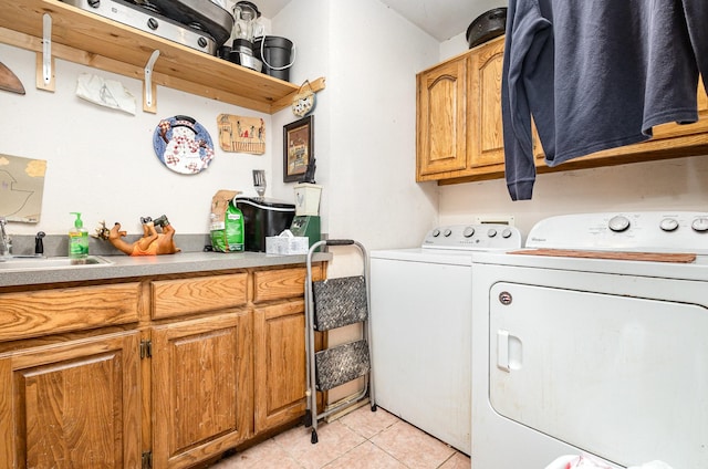 laundry room featuring cabinets, independent washer and dryer, light tile patterned floors, and sink