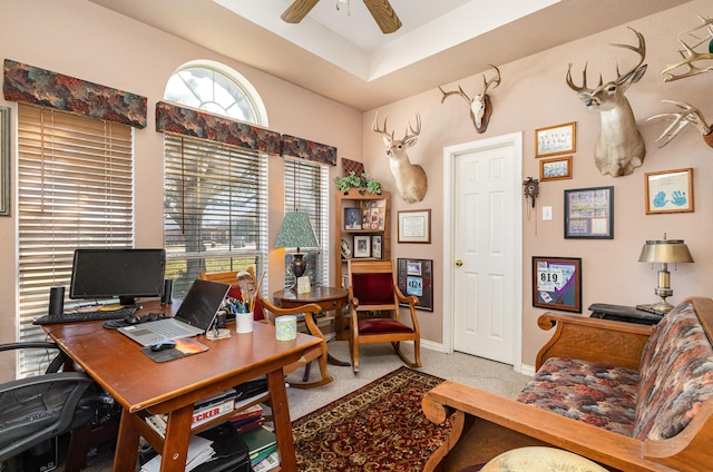 carpeted home office with ceiling fan