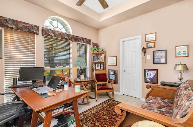 carpeted office with ceiling fan