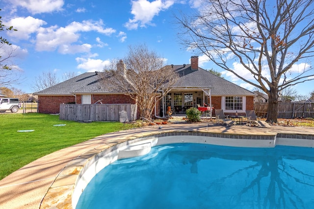 view of pool featuring a yard and a patio area