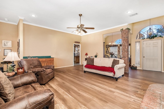 living room featuring light wood-type flooring, ceiling fan with notable chandelier, and crown molding