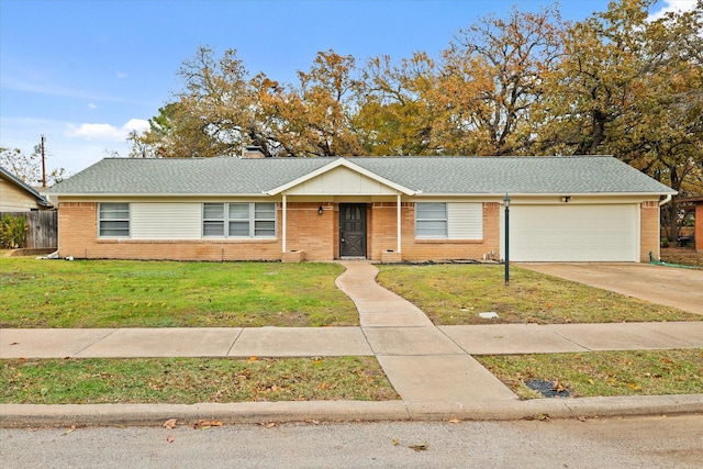 single story home featuring a front lawn and a garage