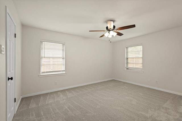 carpeted empty room featuring ceiling fan