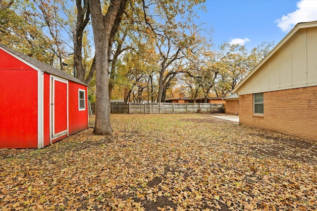 view of yard featuring a shed and a patio