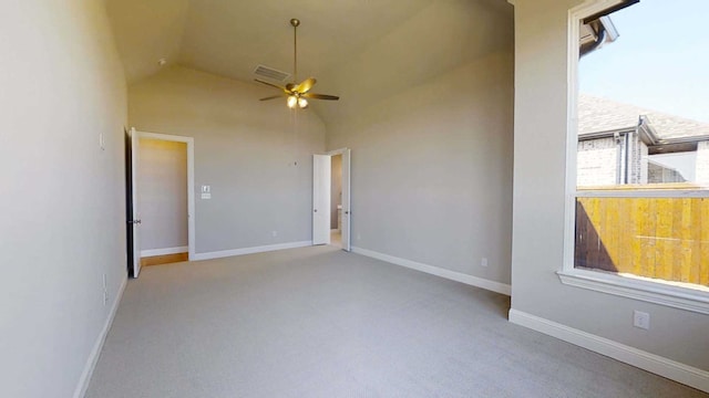 carpeted spare room featuring ceiling fan and high vaulted ceiling