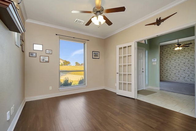 empty room featuring ceiling fan, ornamental molding, and wood-type flooring