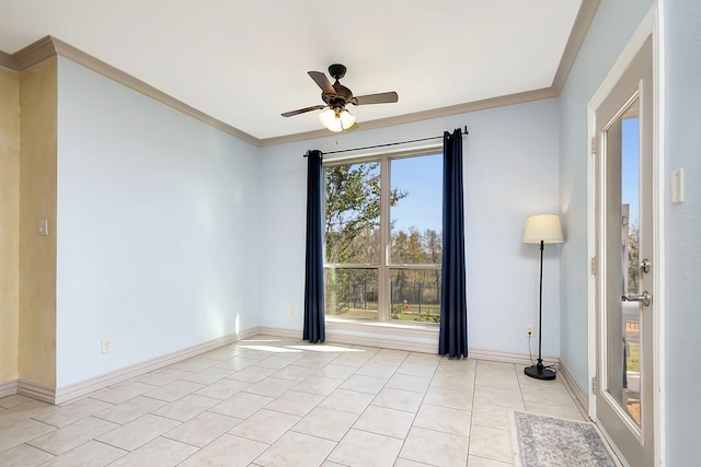 spare room with ceiling fan, ornamental molding, and light tile patterned floors