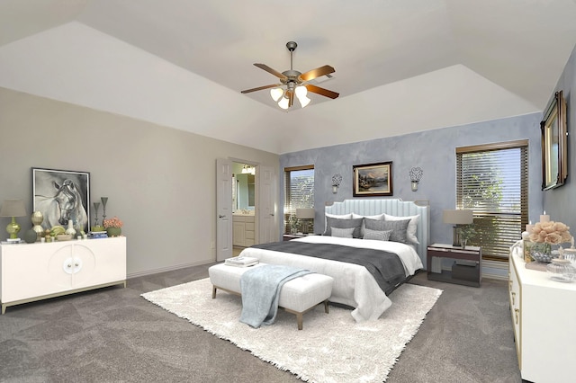 carpeted bedroom featuring multiple windows, connected bathroom, vaulted ceiling, and ceiling fan