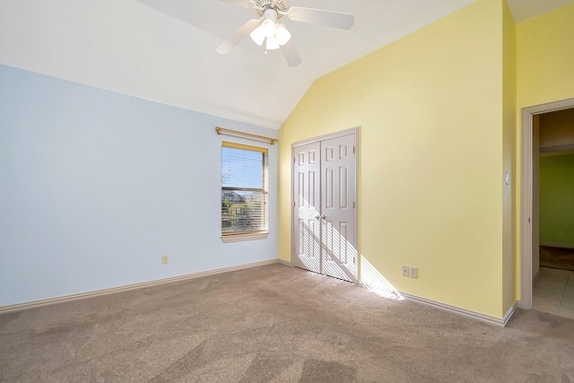 unfurnished bedroom with ceiling fan, carpet flooring, vaulted ceiling, and a closet