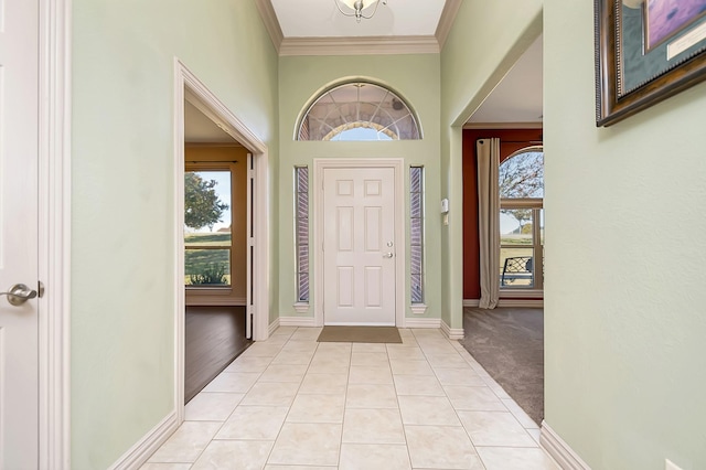 entryway featuring ornamental molding and light carpet