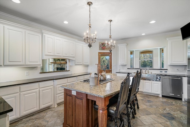 kitchen featuring a kitchen island, white cabinetry, stainless steel appliances, and hanging light fixtures