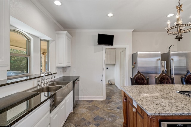 kitchen featuring appliances with stainless steel finishes, stone countertops, white cabinetry, and ornamental molding