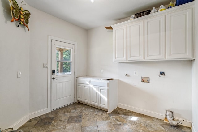 laundry room with washer hookup and cabinets