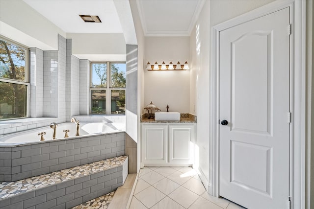 bathroom featuring tile patterned flooring, vanity, a healthy amount of sunlight, and a relaxing tiled tub