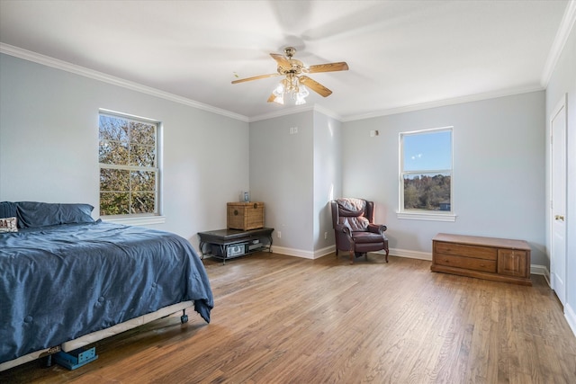 bedroom with ceiling fan, ornamental molding, and light wood-type flooring