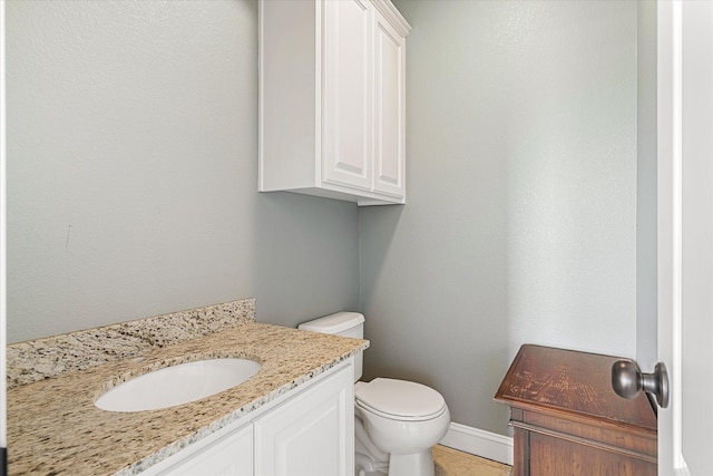 bathroom featuring tile patterned floors, vanity, and toilet