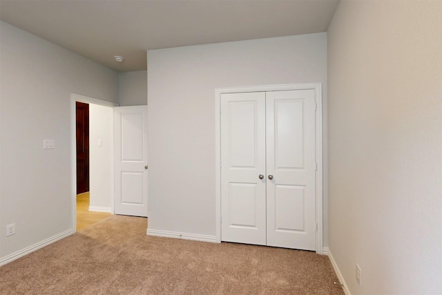 7220 Monarch Trl, Mckinney, TX 75071 - unfurnished bedroom with light carpet, baseboards, and a closet