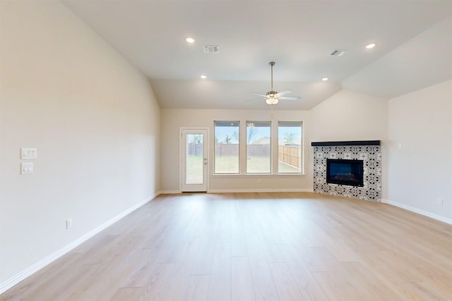 7220 Monarch Trl, Mckinney, TX 75071 - unfurnished living room featuring light wood-type flooring, vaulted ceiling, a ceiling fan, baseboards, and a fireplace