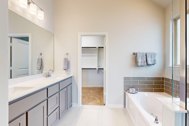 7220 Monarch Trl, Mckinney, TX 75071 - bathroom featuring double vanity, a bath, healthy amount of natural light, and a walk in closet