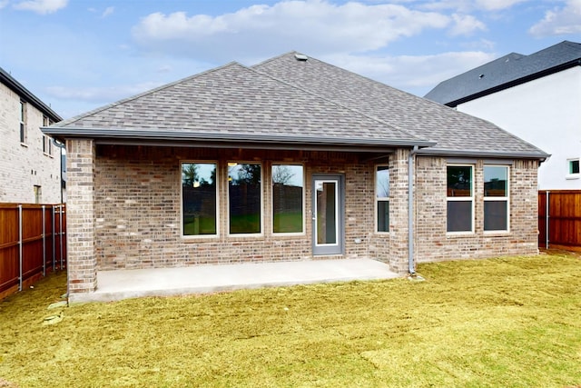 7220 Monarch Trl, Mckinney, TX 75071 - back of property with a shingled roof, brick siding, and a patio area