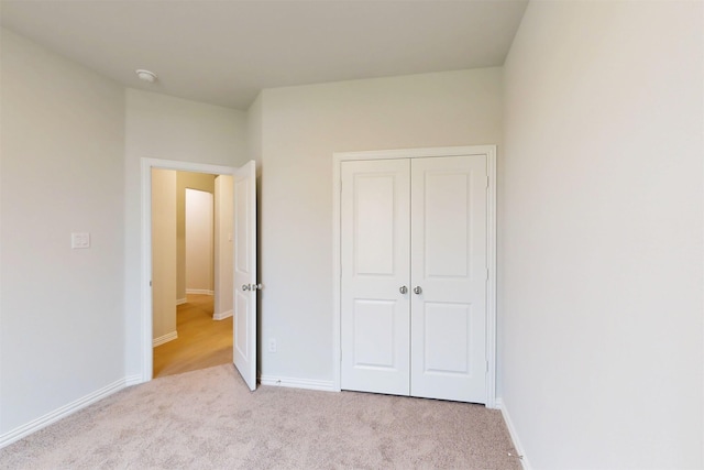 7220 Monarch Trl, Mckinney, TX 75071 - unfurnished bedroom with light colored carpet, a closet, and baseboards