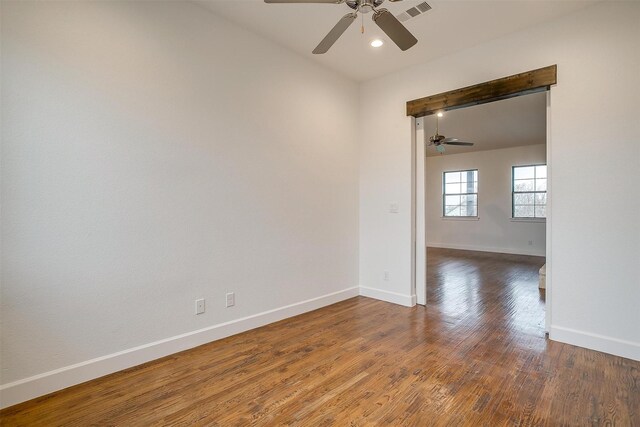 spare room with ceiling fan and dark hardwood / wood-style flooring