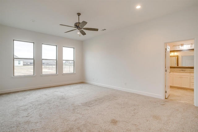 carpeted empty room featuring ceiling fan