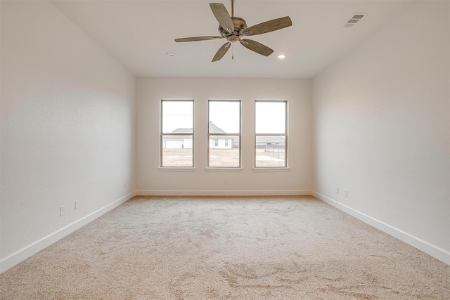 carpeted empty room featuring ceiling fan