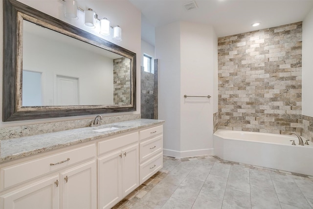 bathroom with vanity and a bath