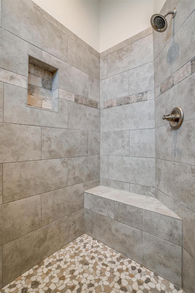 bathroom with tiled shower