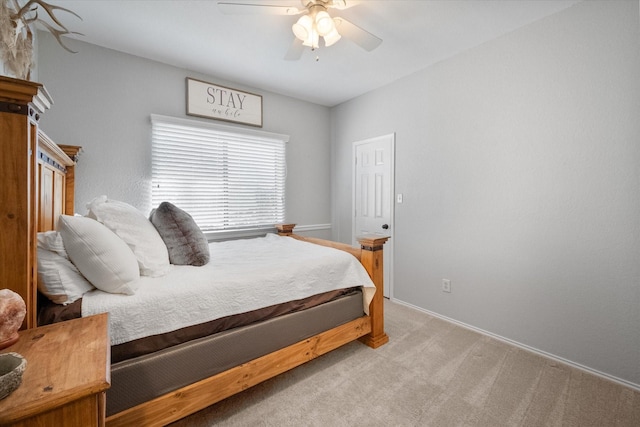 bedroom with ceiling fan and light colored carpet