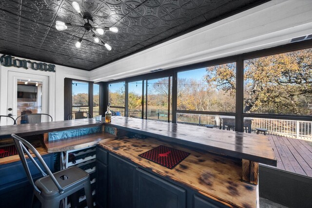 interior space featuring butcher block counters and blue cabinetry