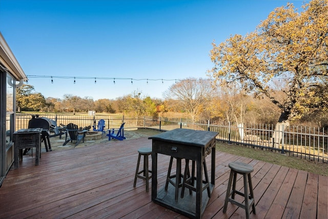 wooden terrace with a fire pit