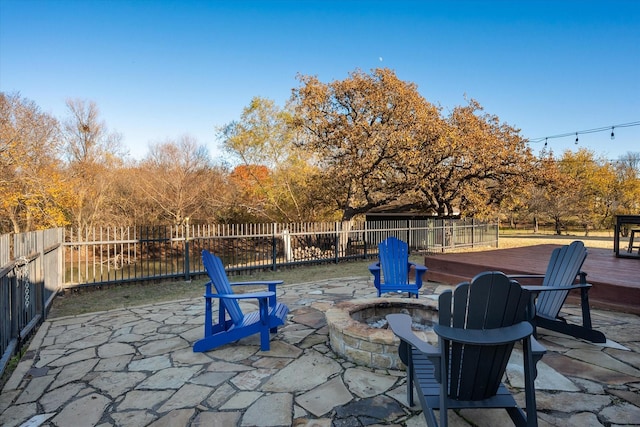 view of patio / terrace featuring a fire pit and a wooden deck