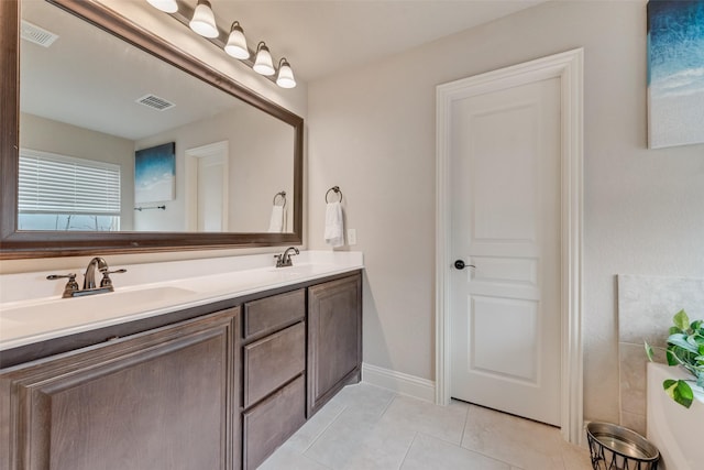 bathroom featuring tile patterned flooring and vanity