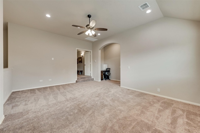 unfurnished living room featuring ceiling fan, light colored carpet, and vaulted ceiling