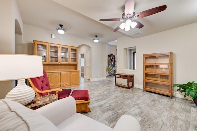 living room with ceiling fan and light hardwood / wood-style floors