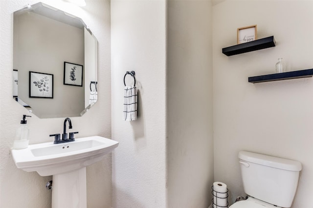 bathroom featuring sink and toilet