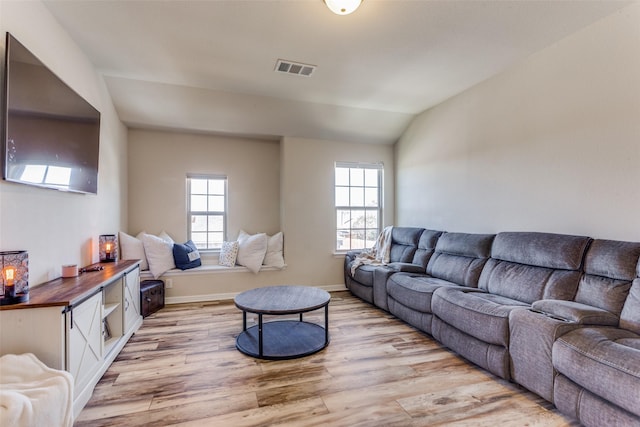 living room featuring light hardwood / wood-style floors and lofted ceiling