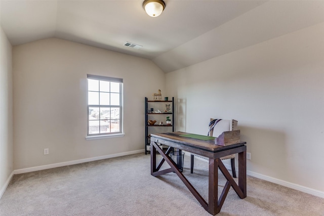 carpeted home office featuring vaulted ceiling