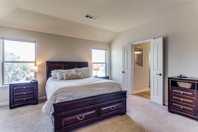 carpeted bedroom featuring vaulted ceiling