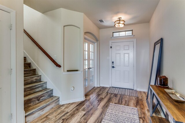 entrance foyer with hardwood / wood-style floors and french doors