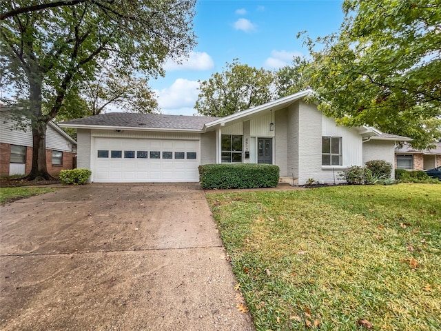 ranch-style house featuring a garage and a front lawn