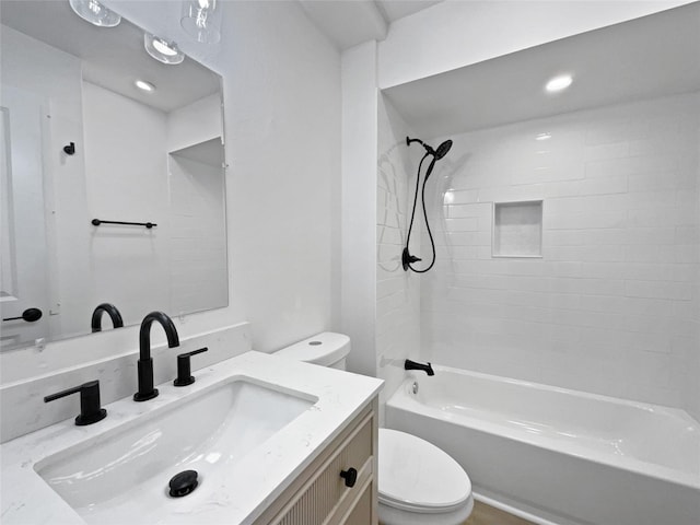 full bathroom with vanity, tiled shower / bath, and toilet