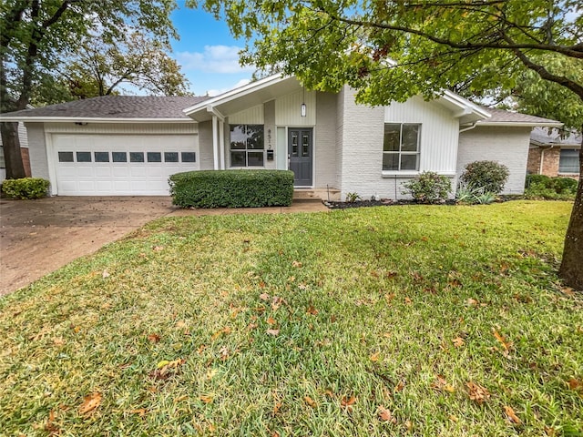 ranch-style home featuring a garage and a front yard