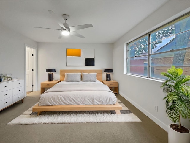 bedroom with dark colored carpet and ceiling fan