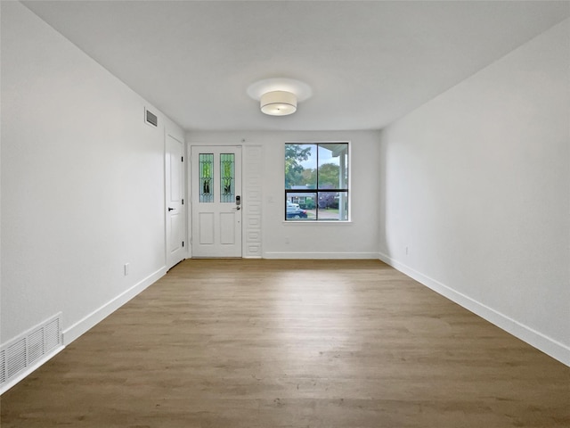 spare room with wood-type flooring