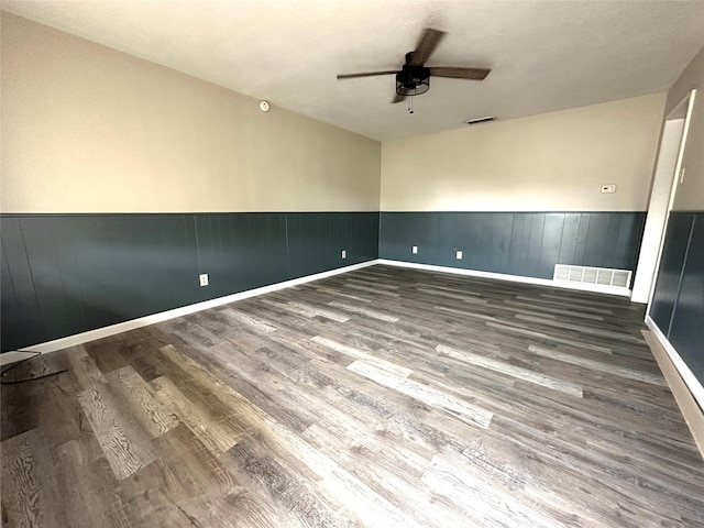 spare room with ceiling fan and dark hardwood / wood-style flooring